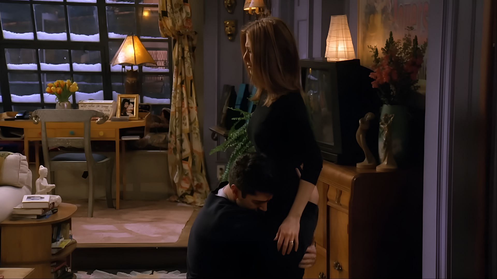 Ross clings to Rachel in desperation as she tries to walk away. One of the most emotionally raw moments, where Ross’s fear of losing Rachel completely overtakes him. (Image via Netflix)